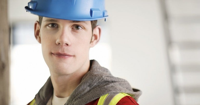 Young worker with safety hat and vest