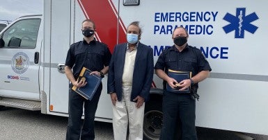 TIMELY INTERVENTION--Summerland bylaw officers Darren Krell, left, and Dan Maja, right, pose with Al Klar on September 17 after being presented with Vital Link awards from the local ambulance service for saving Klar’s life.